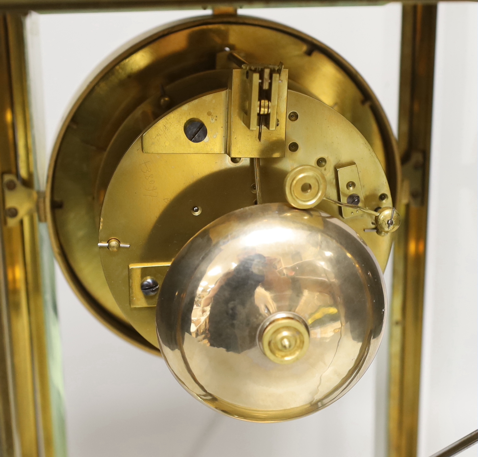 An early 20th century French brass four-glass mantel clock with enamel dial inscribed Garnier, 36cm high